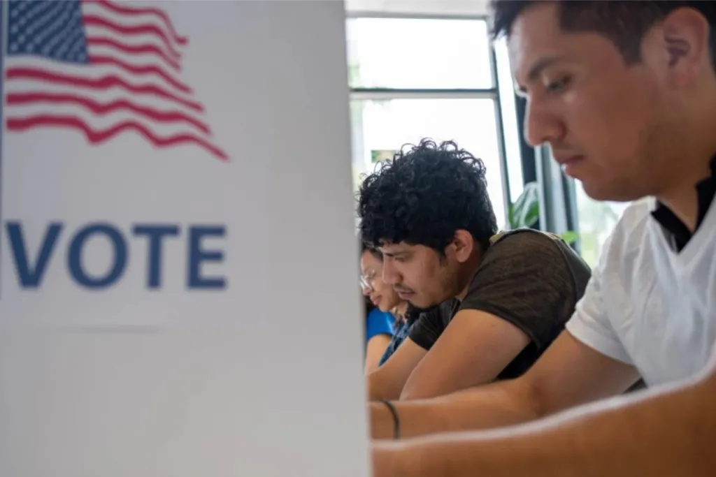 Latino voters photographed at the ballot box