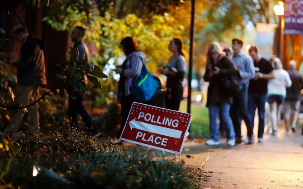 A photo of voters standing in line at a polling place