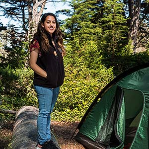 Beatriz Rivera of GGNPC, setting up a tent area in Rob Hill Campground in the Presidio of San Francisco