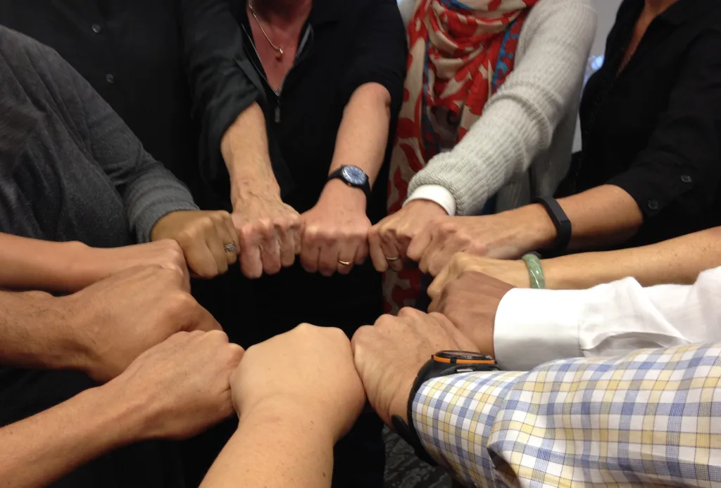 Group of hands together in a circle