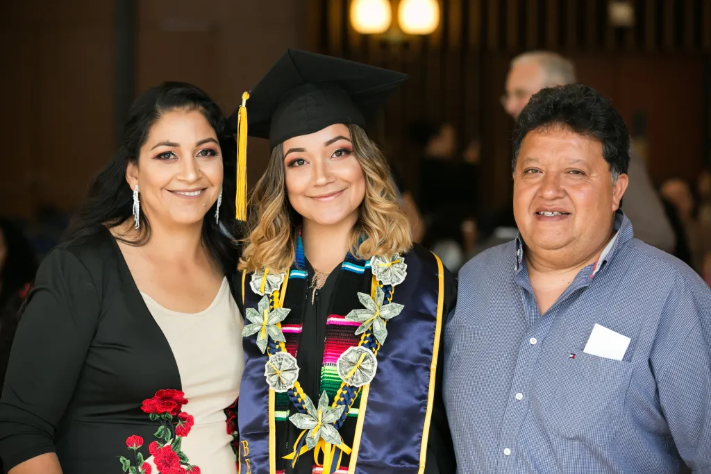 Undocumented graduate with her parents