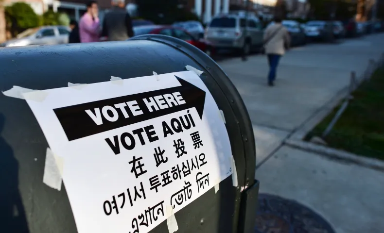 Voting location sign in four different languages