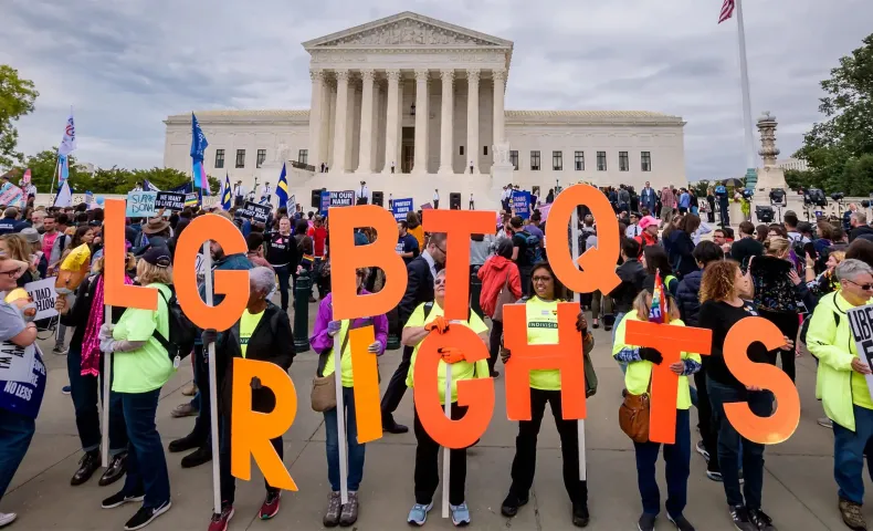 Protesters holding a banner outside the Supreme Court in 2019