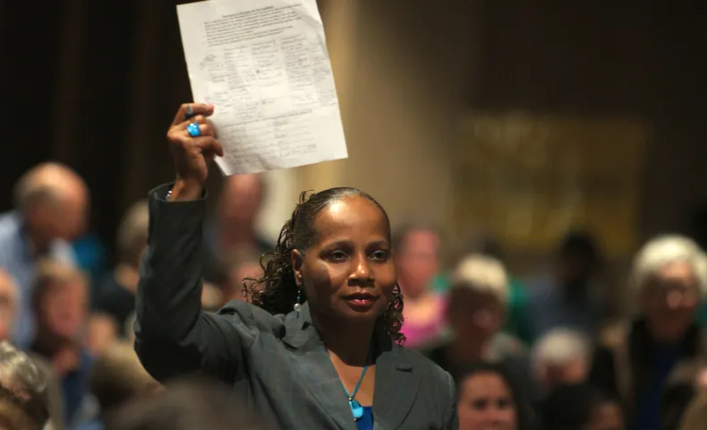 Attendee stands at candidates forum