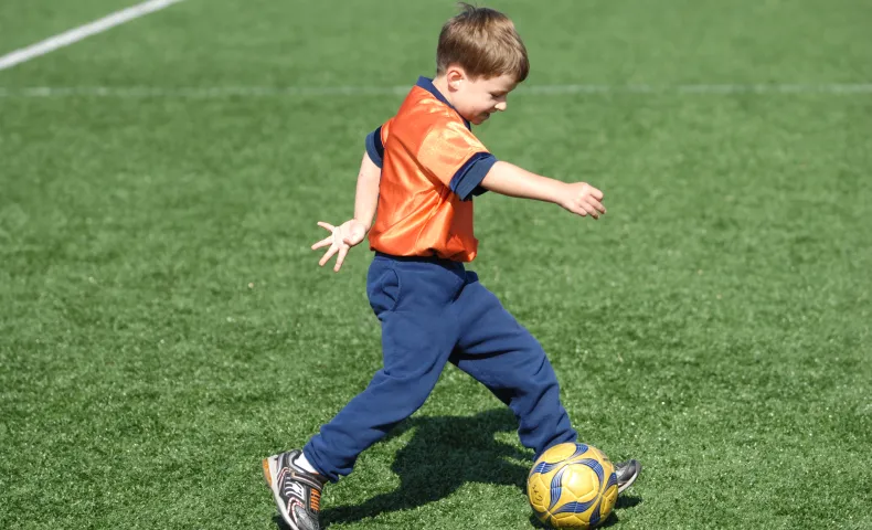 Young boy playing soccer