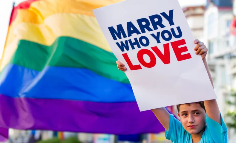 Boy with "Marry Who You Love" sign