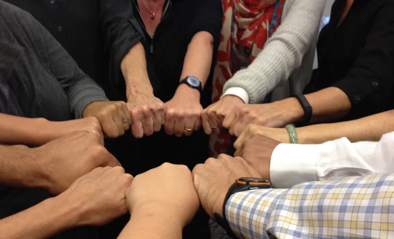 Group of hands together in a circle