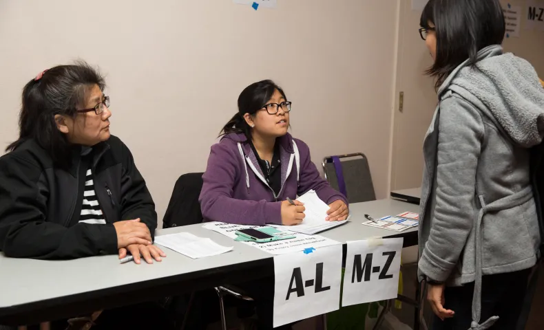 Immigrant support volunteers at naturalization clinic