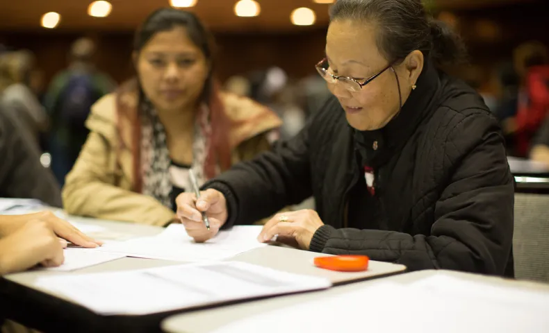 Woman signing papers