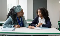 Student conversing with her high school counselor