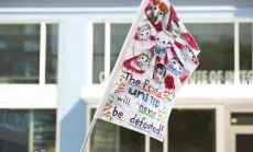 Flag with the words "people united will never be defeated"