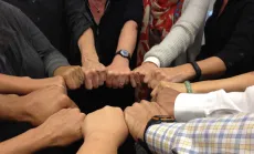 Group of hands together in a circle