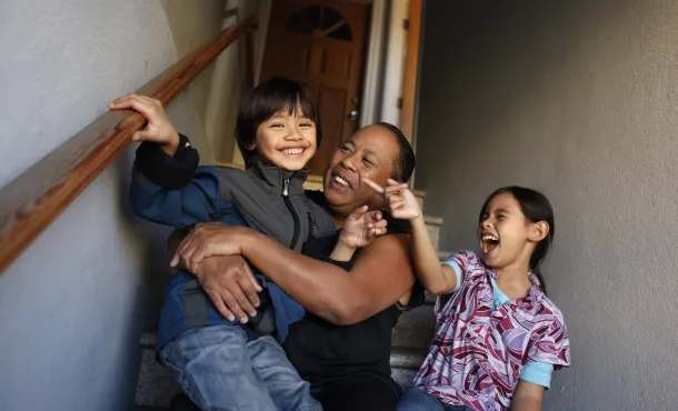 Woman on staircase with two children