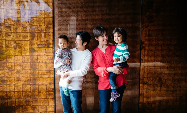 Lesbian couple poses for family portait with their kids in San Francisco