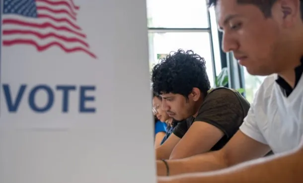 Latino voters photographed at the ballot box