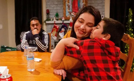 Janet Magana de Cuevas hugs her youngest son, Ruben Magana de Cuevas, 7, at their Vallejo home.