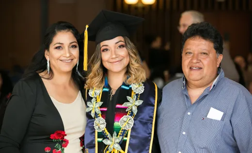 Undocumented graduate with her parents