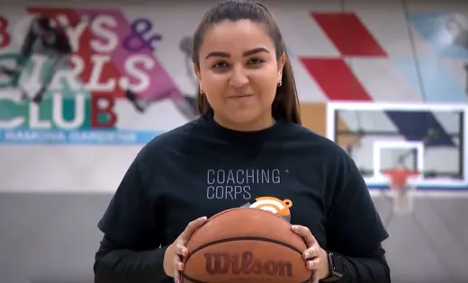 Coach Serena Limas holding basketball.