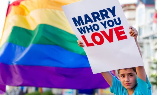 Boy with "Marry Who You Love" sign