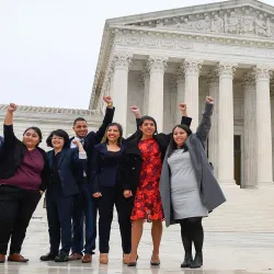 Five students stand in front of SCOTUS with their fist in the air