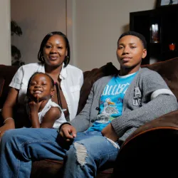 Woman with her teenage son and grade school daughter on a couch