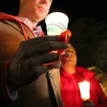 Man holding candle at World Aids Day
