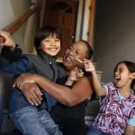 Woman on staircase with two children