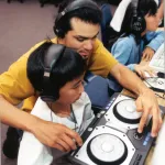 Student with teacher in computer and music lab