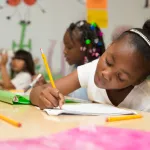 Children writing in the classroom