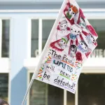 Flag with the words "people united will never be defeated"