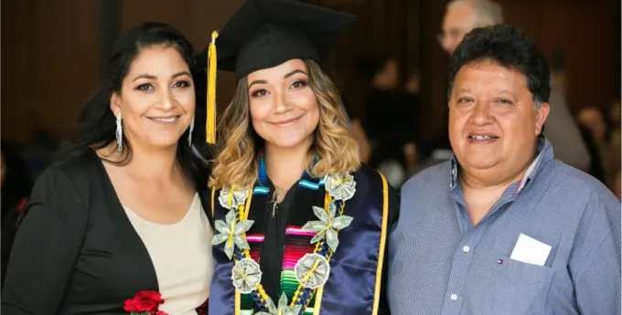 A college graduate photographed with her family.