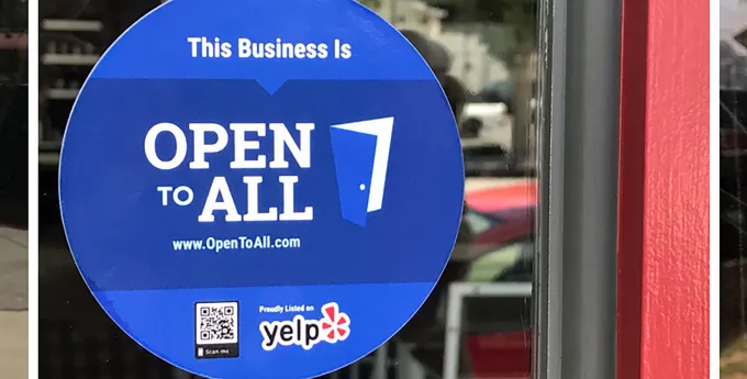 "Open to All" sign in window