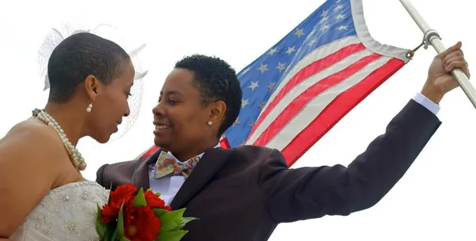 Lesbian couple with american flag on wedding day