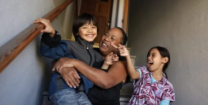 Woman on staircase with two children