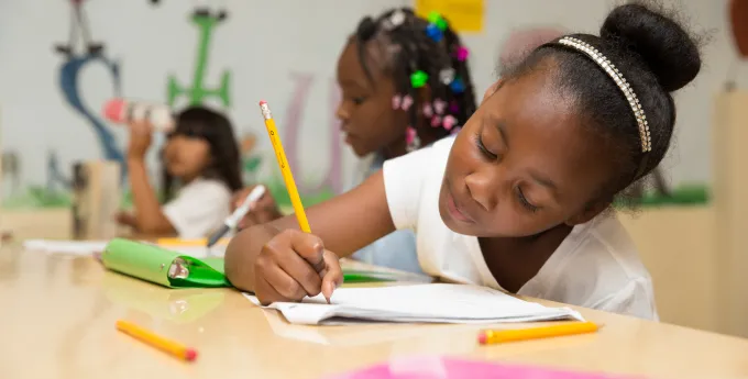 Children writing in the classroom