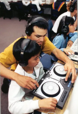 Student with teacher in computer and music lab